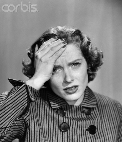 1950s Stressed Woman In Striped Dress Hold Forehead With Hand