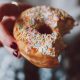 selective focus photograph of half eaten doughnut with sprinkles